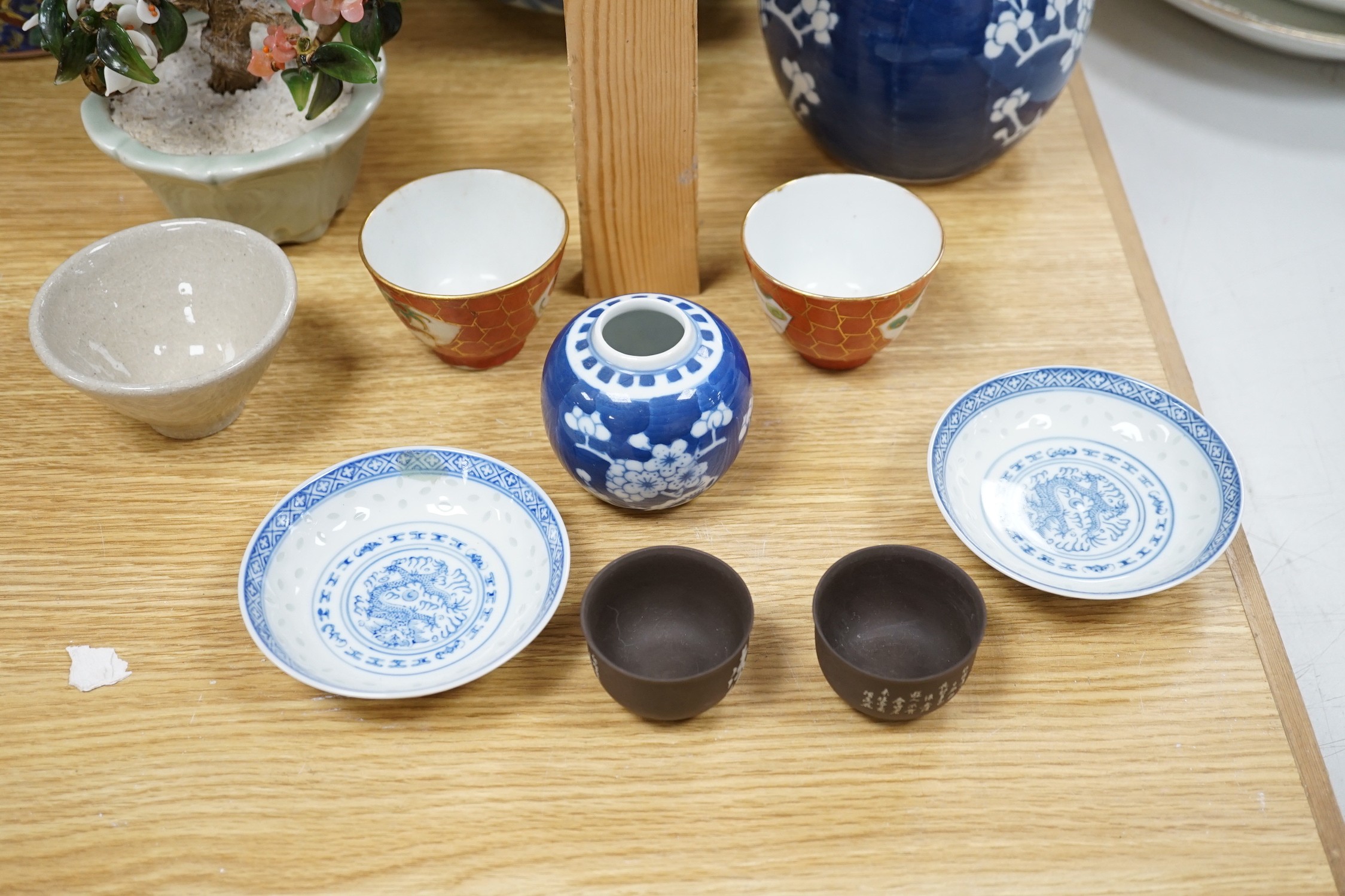 A group of various Chinese ceramics, to include a blue and white prunus jar, an earthenware dish, a famille rose jar and cover and others